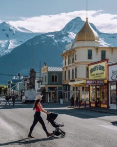 Mom pushing stroller in historic downtown Skagway Alaska